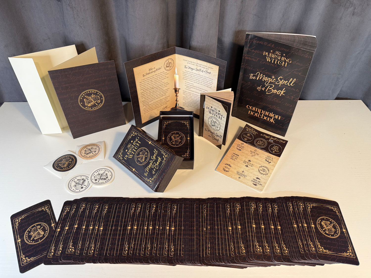 Collection of mystical cards on a white surface with a gray curtain background.